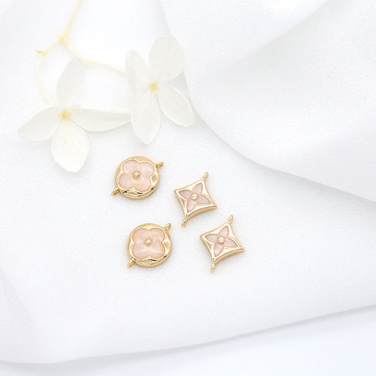 10 doppelt geschlungene Kreuz-Blumen-Charm-Verbindungsstücke aus Kunstharz, verziert mit 14-karätigem GF